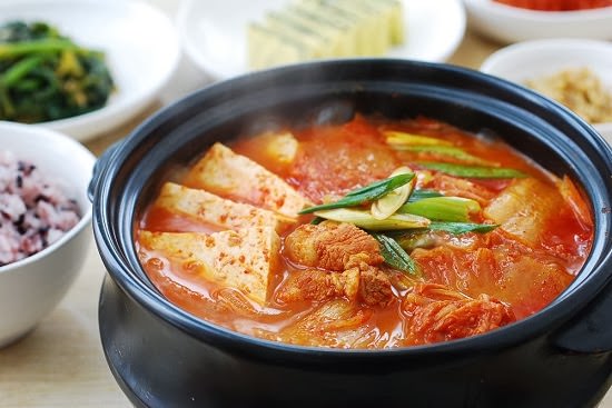 This is a korean cuisine, it is a kimchi stew which contain kimchi and other ingredients.